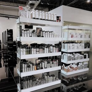 Shelves display various hair care and beauty products in a modern, brightly lit store interior.
